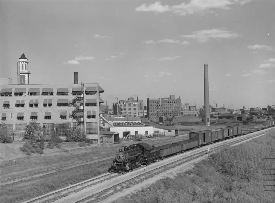 fire escape, Cities and Towns, brick building, train track, train car, smokestack, Iowa History, history of Iowa, train, parking lot, Library of Congress, Iowa, Businesses and Factories, steam engine