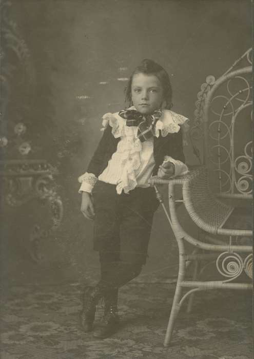 Children, chair, wicker chair, little lord fauntleroy suit, painted backdrop, Schlawin, Kent, Iowa History, Iowa, curls, history of Iowa, boy, Portraits - Individual, IA