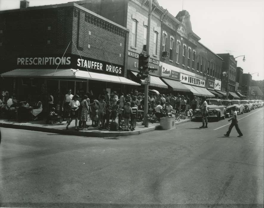 automobile, paint store, Motorized Vehicles, Main Streets & Town Squares, street parking, drugstore, correct date needed, Iowa History, Waverly, IA, Waverly Public Library, Cities and Towns, jewelry store, clothing store, Iowa, Businesses and Factories, crowd, awning, history of Iowa