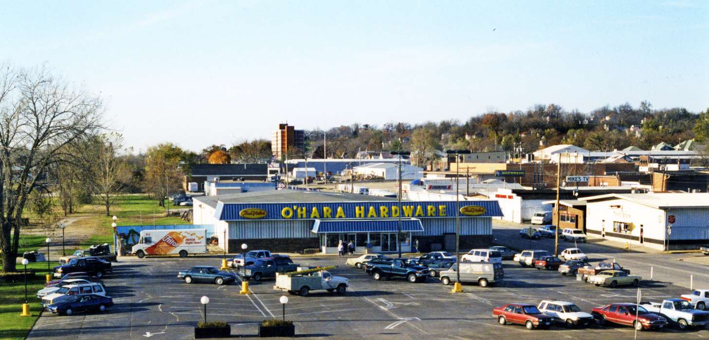 hardware store, ford, Businesses and Factories, Motorized Vehicles, history of Iowa, parking lot, Lemberger, LeAnn, lays, fritos, Aerial Shots, car, Iowa, small business, Iowa History, store, Ottumwa, IA