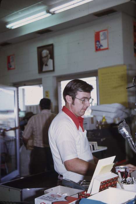 Businesses and Factories, Food and Meals, candid, Adair, history, cashier, Photos, glasses, Labor and Occupations, Iowa, IA, public announcement microphone, Cities and Towns, Greenfield, United States, ia, grocery store, supermarket, historic, Comstock, Sara