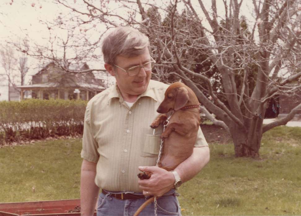 dachshund, Adair, history, collar, Photos, glasses, Outdoor Recreation, grass, Animals, shrubs, button up, Iowa, IA, Cities and Towns, dog, Homes, tree, Greenfield, Portraits - Individual, belt, chain, United States, ia, bush, leafless trees, man, historic, jeans, house, Comstock, Sara