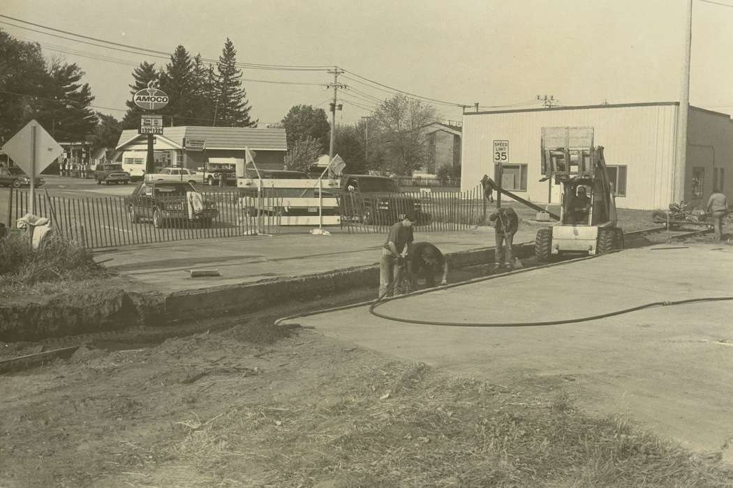 Waverly Public Library, construction crew, Iowa History, car, gas pump, forklift, gas station, truck, hole, railroad track, fence, Main Streets & Town Squares, Waverly, IA, Labor and Occupations, Iowa, history of Iowa, Motorized Vehicles, Businesses and Factories