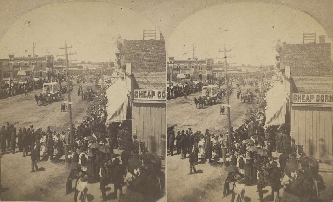 telephone pole, crowds, parade float, Entertainment, Waverly, IA, drugstore, horse and cart, e. bremer ave., history of Iowa, saloon, Iowa History, brick building, dentist, Iowa, Waverly Public Library, horse and buggy, Main Streets & Town Squares, suits, bank