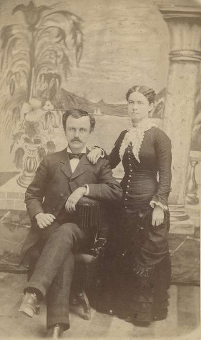 frock coat, Olsson, Ann and Jons, lace collar, woman, mustache, correct date needed, bow tie, couple, man, carte de visite, Iowa History, Portraits - Group, Families, painted backdrop, Iowa, history of Iowa, IA
