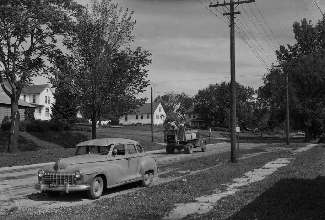 car, IA, Cities and Towns, spray, historic, Motorized Vehicles, Coon Rapids, neighborhood, Iowa, United States, Photos, Labor and Occupations, two men, dump truck, shoveling, history, ia, Coon Rapids Enterprise