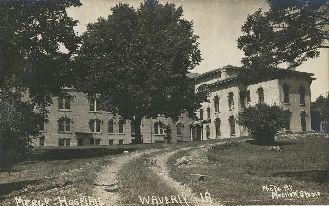 dirt path, Meyer, Mary, Hospitals, Iowa History, hospital, brick building, windows, Iowa, trees, mercy hospital, history of Iowa