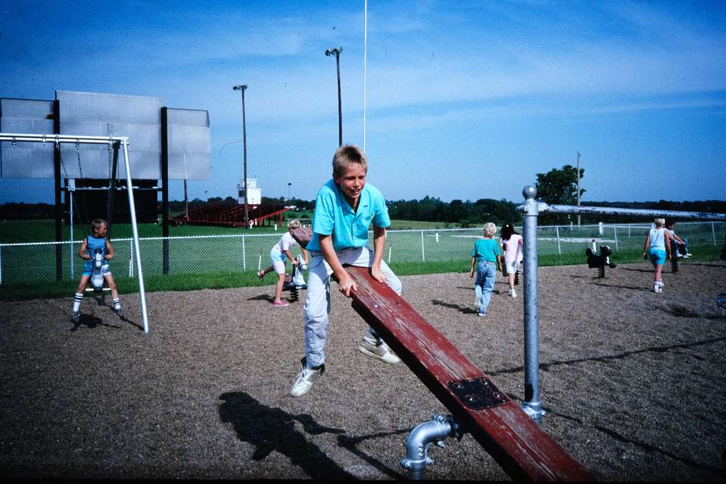 school trip, playground equipment, Children, chain link fence, Travel, see-saw, history, Iowa, Coon Rapids Enterprise, boy, second grade missouri trip, playground, Photos, Leisure, teeter totter, ia, United States, rocking horse, missouri trip, park, MO, historic