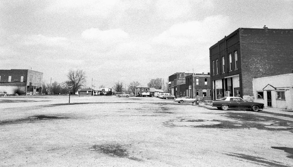 parking lot, Cities and Towns, dirt road, Lemberger, LeAnn, Iowa History, car, stop sign, storefront, Main Streets & Town Squares, Cincinnati, IA, Iowa, history of Iowa, Motorized Vehicles, Businesses and Factories