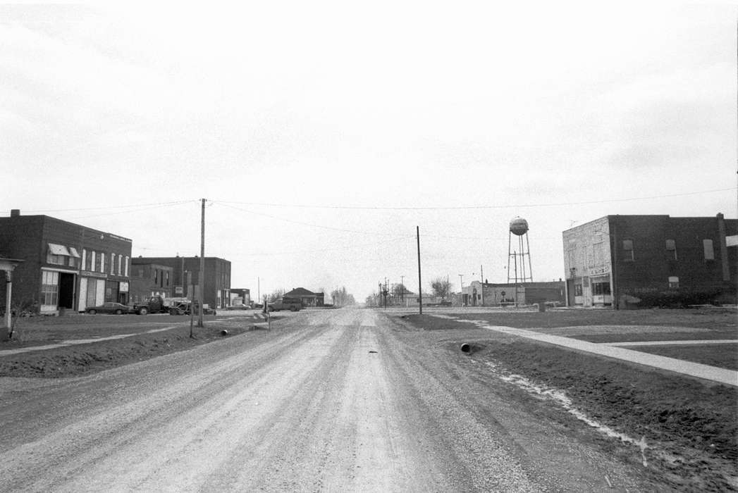 Cities and Towns, Lemberger, LeAnn, Iowa History, Iowa, history of Iowa, Cincinnati, IA, Businesses and Factories, Main Streets & Town Squares, water tower, storefront, dirt road, truck, ditch