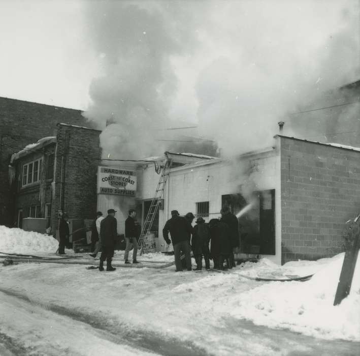 Businesses and Factories, Labor and Occupations, hardware store, firefighter, Wrecks, hose, sign, Iowa History, Winter, Iowa, Waverly Public Library, fireman, ladder, Cities and Towns, history of Iowa, smoke