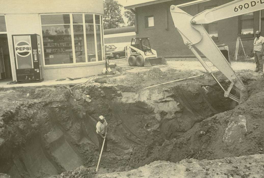 Waverly Public Library, Iowa History, gas station, car, hole, brick building, Waverly, IA, pop machine, Businesses and Factories, Motorized Vehicles, Labor and Occupations, Iowa, history of Iowa, excavator, bobcat loader